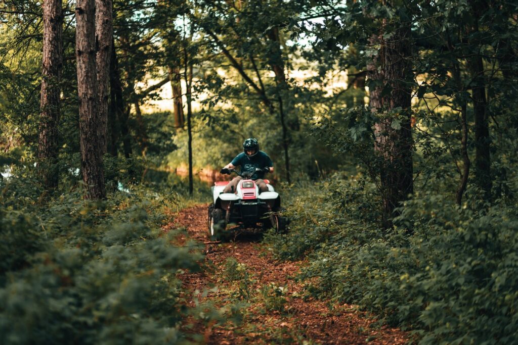Man on an ATV in a forest area